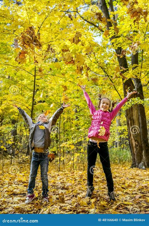 Happy Children Throwing Leaves Up Stock Photo - Image: 48166640