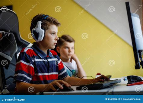 Two Kids Boys Playing Computer Games on Desktop Pc. Modern Addict ...