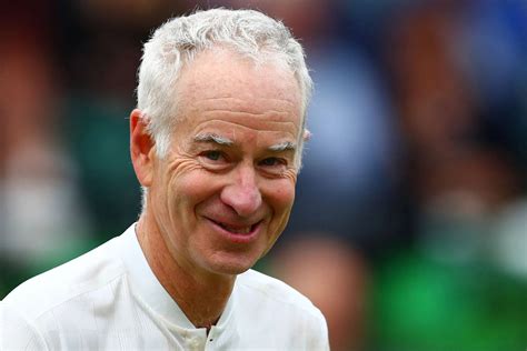 Download John McEnroe Smiling Broadly in a Casual Moment Wallpaper | Wallpapers.com