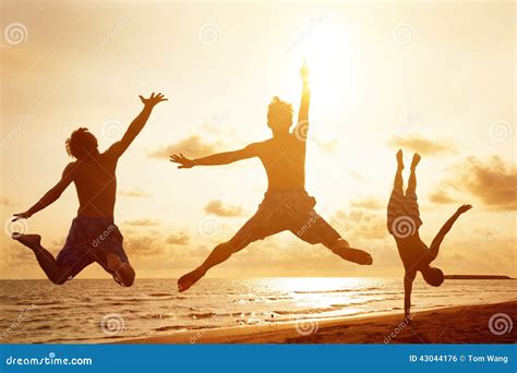 Young People Jumping on the Beach with Sunset Stock Photo - Image of ...