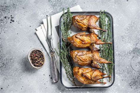 Premium Photo | Homemade sticky Roast quails with spices and herbs in a baking dish Gray ...