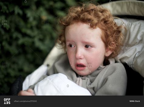 Scared little girl crying stock photo - OFFSET