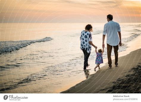 Family walking on beach - a Royalty Free Stock Photo from Photocase