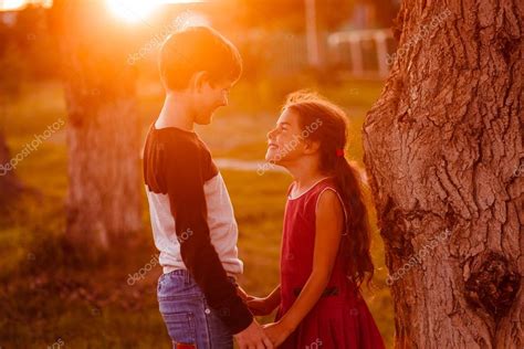 Boy girl teens are holding hands romance friendship love at suns — Stock Photo © maxximmm1 #79518810