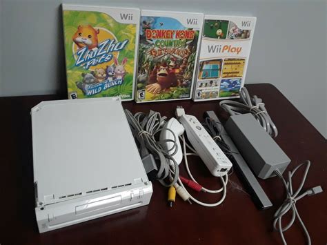 Nintendo Wii White Console with three games and a few controllers ...