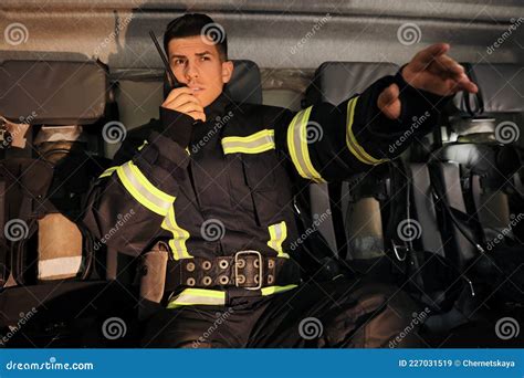 Firefighter Using Portable Radio Set in Fire Truck Stock Image - Image of background, drive ...