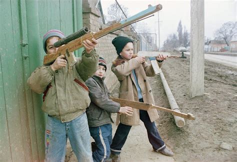 Young children imitate Chechen rebels after the Russian invasion of ...