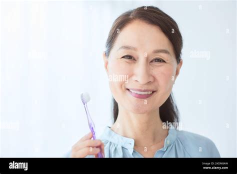 Japanese senior woman brushing teeth Stock Photo - Alamy