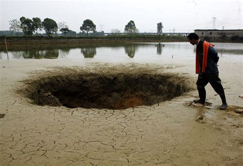 A Sinkhole Opens Up in a Fish Pond Picture | Incredible sinkholes ...