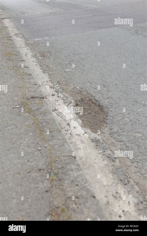 Pot holes in Carterton, Oxfordshire UK. 13th May 2018. UK Weather: Pot holes in West Oxfordshire ...