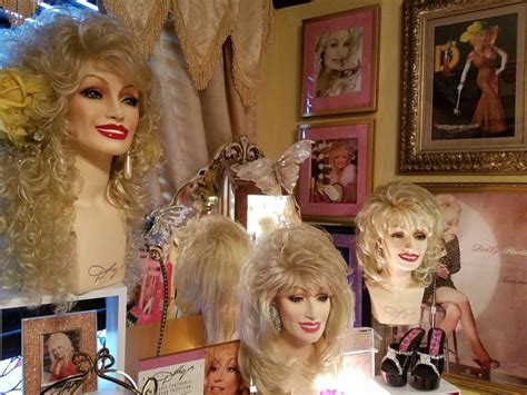 there are many wigs on display in this room with pictures and frames around them