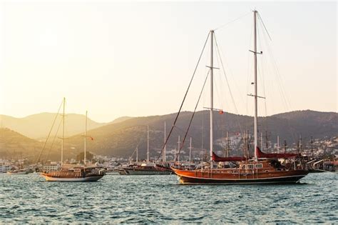 Premium Photo | Bodrum cruise port with sailing yachts at sunset beautiful view of bodrum marina ...