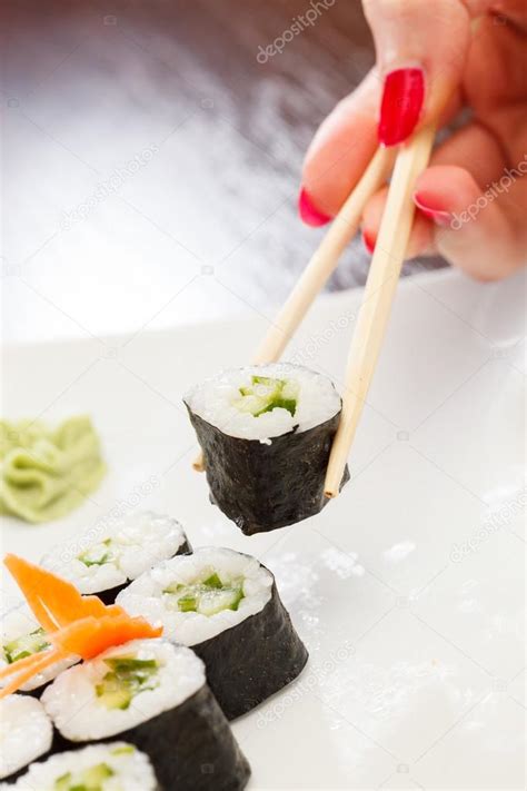 Sushi with chopsticks Stock Photo by ©Shebeko 25962411