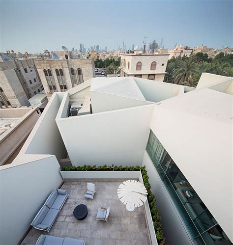 AGi architects hides wall house in kuwait behind stone façade