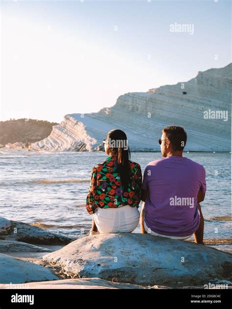 Scala dei Turchi, a couple watching the sunset at the white cliffs of ...