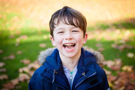 Young boy laughing outside, in park during Beckenham family photoshoot - Tessa Clements Photography