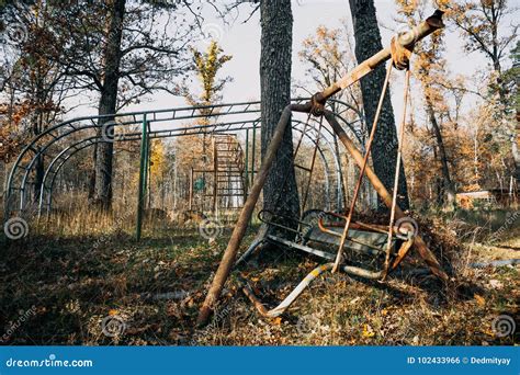 Creepy Abandoned Children Playground among Autumn Trees, Rusty Swing Stock Photo - Image of ...