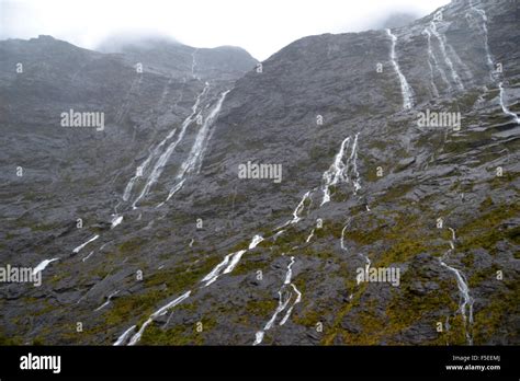 Glacier waterfalls on the road to Milford Sound, Fiordland National Park, South Island, New ...