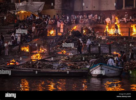 Cremation funeral pyres at early evening. Manikarnika Ghat, Varanasi ...