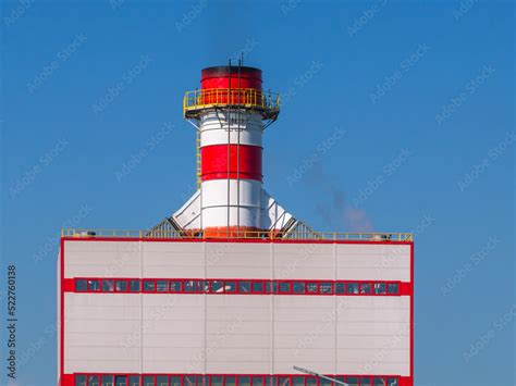 Red and white pipe of a thermal power plant. Conversion of chemical ...
