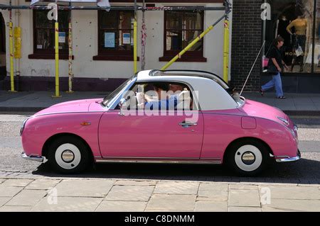 A pink Nissan Figaro car Stock Photo - Alamy