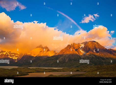 Rainbow over the cuernos del paine mountain peaks at sunrise hi-res ...