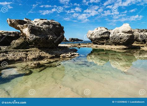 Rock Formation with Reflections in the Sea at Peterborough Beach, Victoria, Australia Stock ...