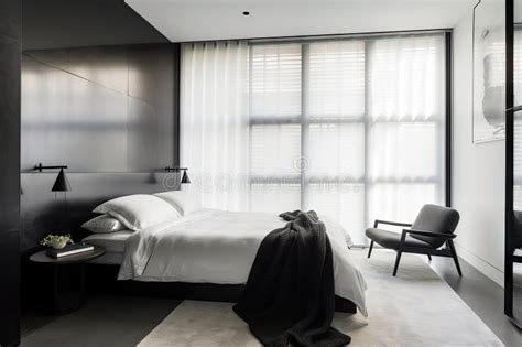 Minimalist Bedroom with Sleek Black Furniture and White Sheets Stock ...