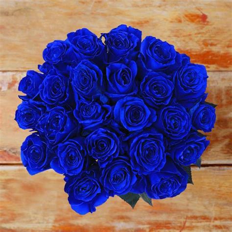 a bouquet of blue roses sitting on top of a wooden table