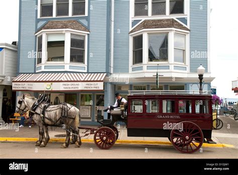 The Grand Hotel horse drawn carriage on Mackinac Island located in Lake Huron, Michigan, USA ...