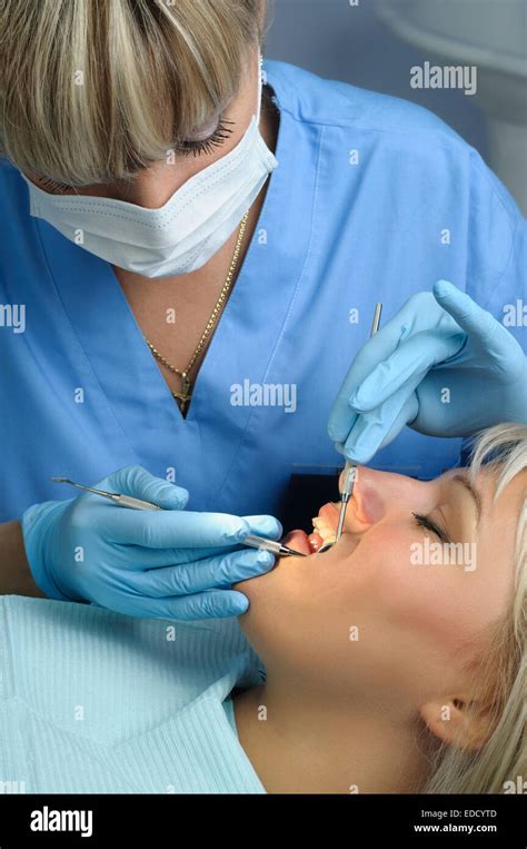 dentist with patient, dental calculus removal Stock Photo - Alamy