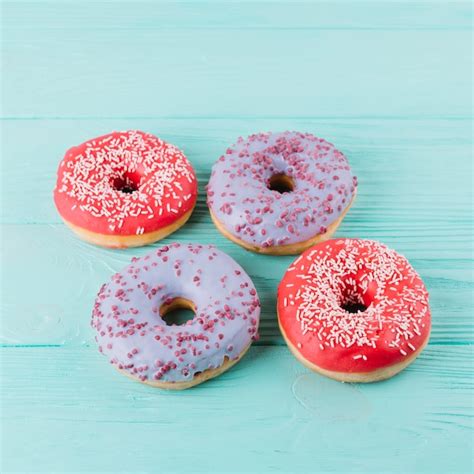 Free Photo | Top view of delicious donut with sprinkles on wooden table