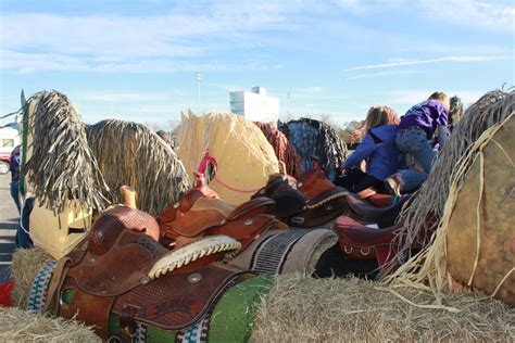 Cardboard horse heads on bales of hay for float in parade. Cowboy ...