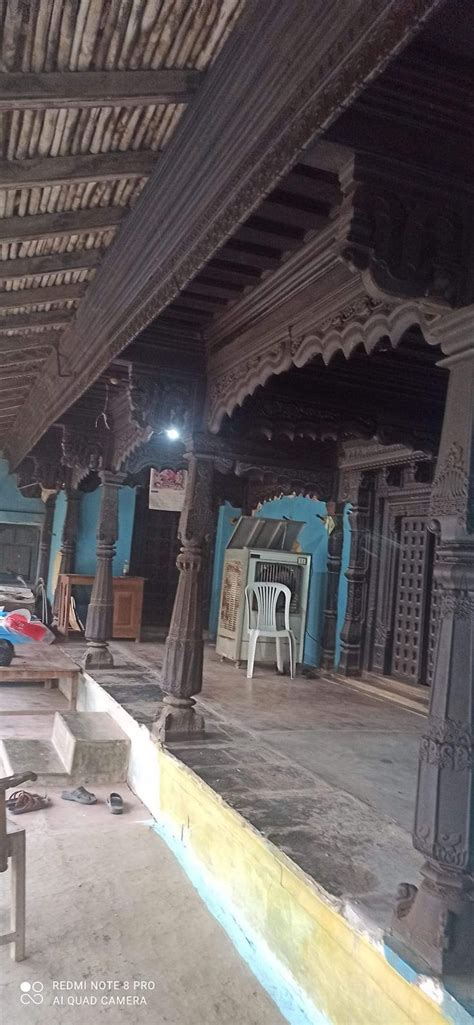 the inside of an old building with benches and tables