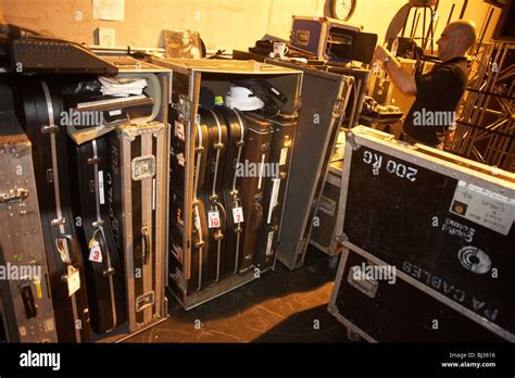 roadie belonging to the crew of British rock and roll band Status Quo starts packing up sound ...