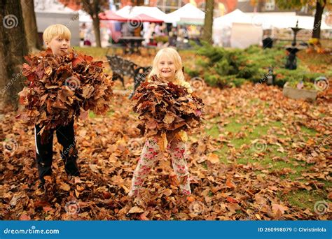 Hapy Little Kids Playing in the Leaves at a Fall Festival Stock Image ...