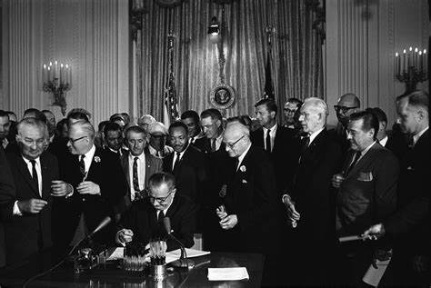 President Lyndon Baines Johnson signing the Civil Rights act of 1964 with Martin Luther King JR ...