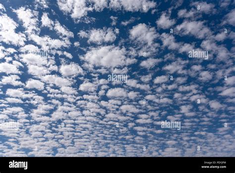 Scattered small white clouds against blue sky, background Stock Photo ...