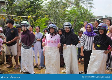 A Group of Indonesian Women with Helmet are Compete Indonesian Traditional Games Called Balap ...