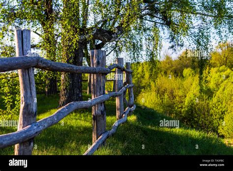 rustic view with log fence on hill Stock Photo - Alamy