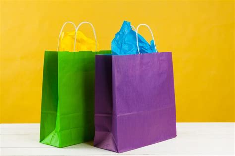 Premium Photo | Paper shopping bags on bright yellow