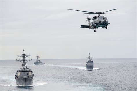 USS Mobile Bay (CG-53), USS Chung Hoon (DDG-93), and USS Russell (DDG-59) take part in a show of ...