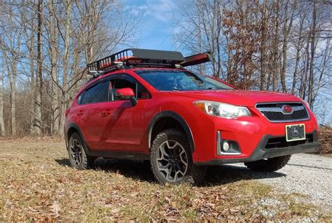 Red Subaru Crosstrek Parked in Front of Trees