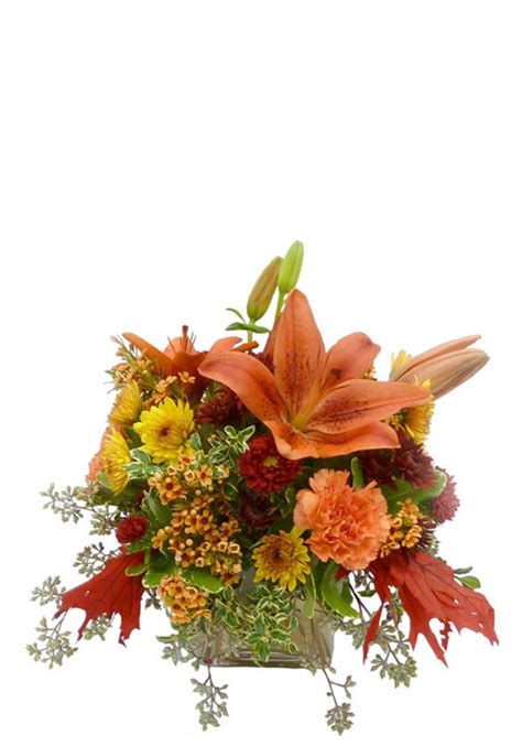 A warm arrangement of autumn flowers in a contemporary vase.