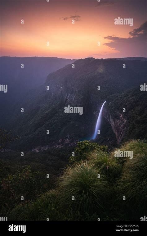 A vertical shot of Nohkalikai Falls at sunset. State of Meghalaya ...