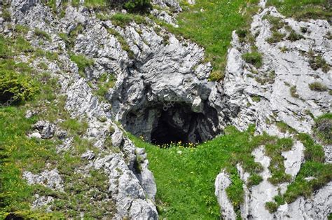 Small cave entrance in the mountains Stock Photo by ©salajean 49220397