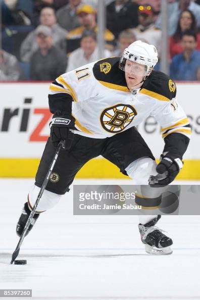 Forward P.J. Axelsson of the Boston Bruins skates with the puck... News ...