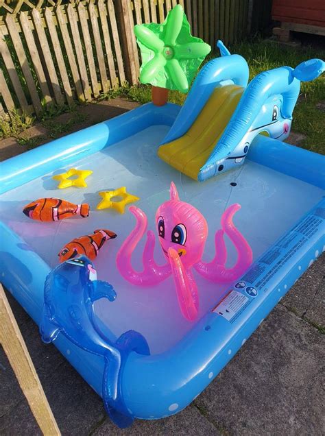 Home Bargains is selling an inflatable paddling pool with a slide and sprinkler for a bargain ...