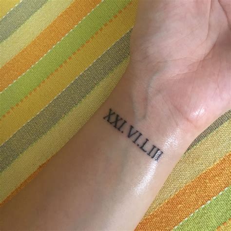 Roman numeral tattoo wrist | Roman numeral wrist tattoo, Small wrist ...