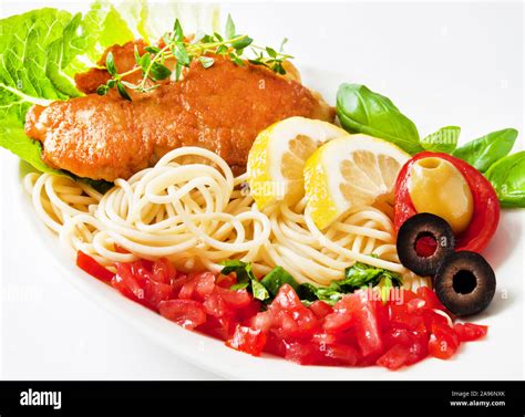 Piccata milanese and pasta Stock Photo - Alamy